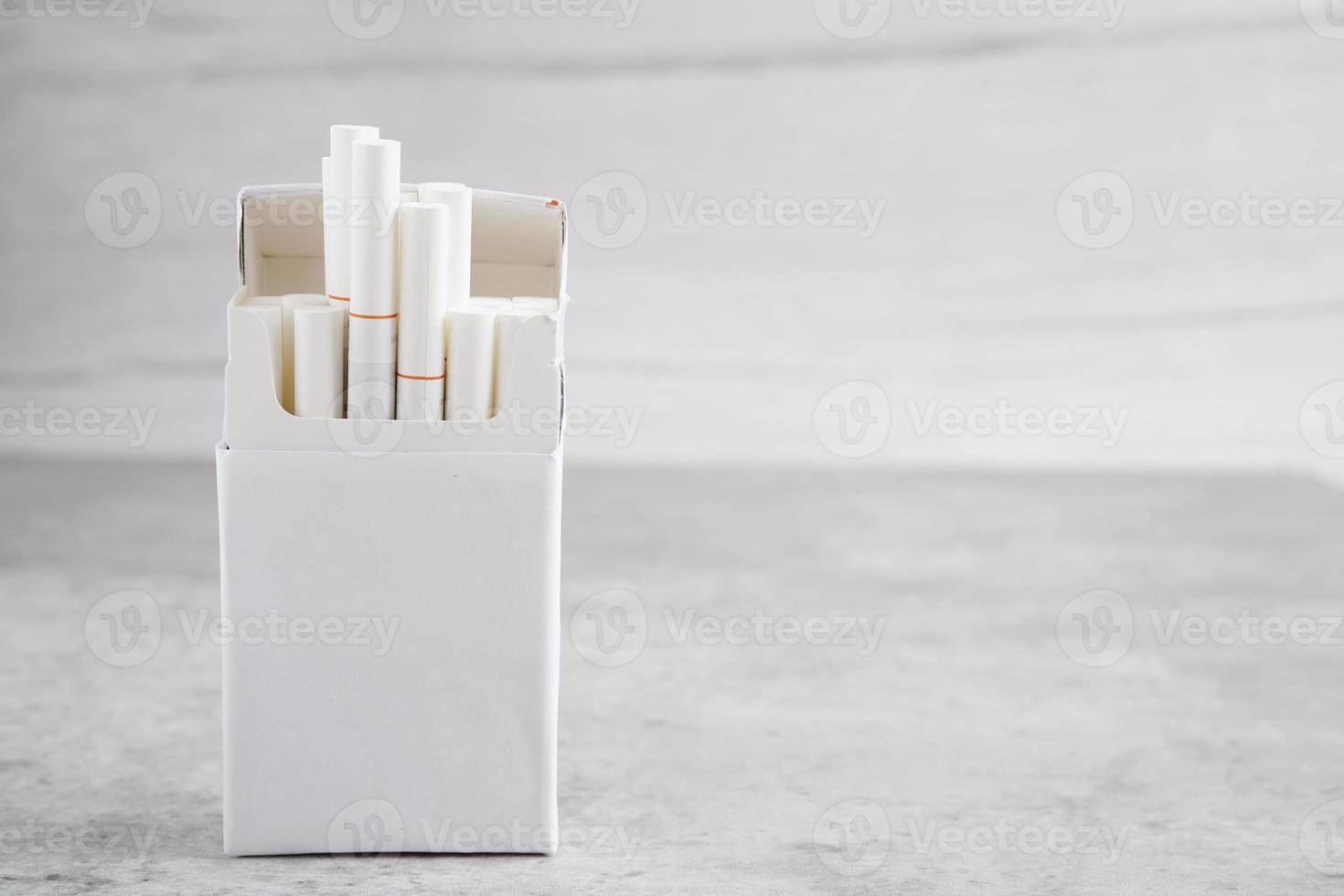 Cigarette in pack, roll tobacco in paper with filter tube, No smoking concept. photo
