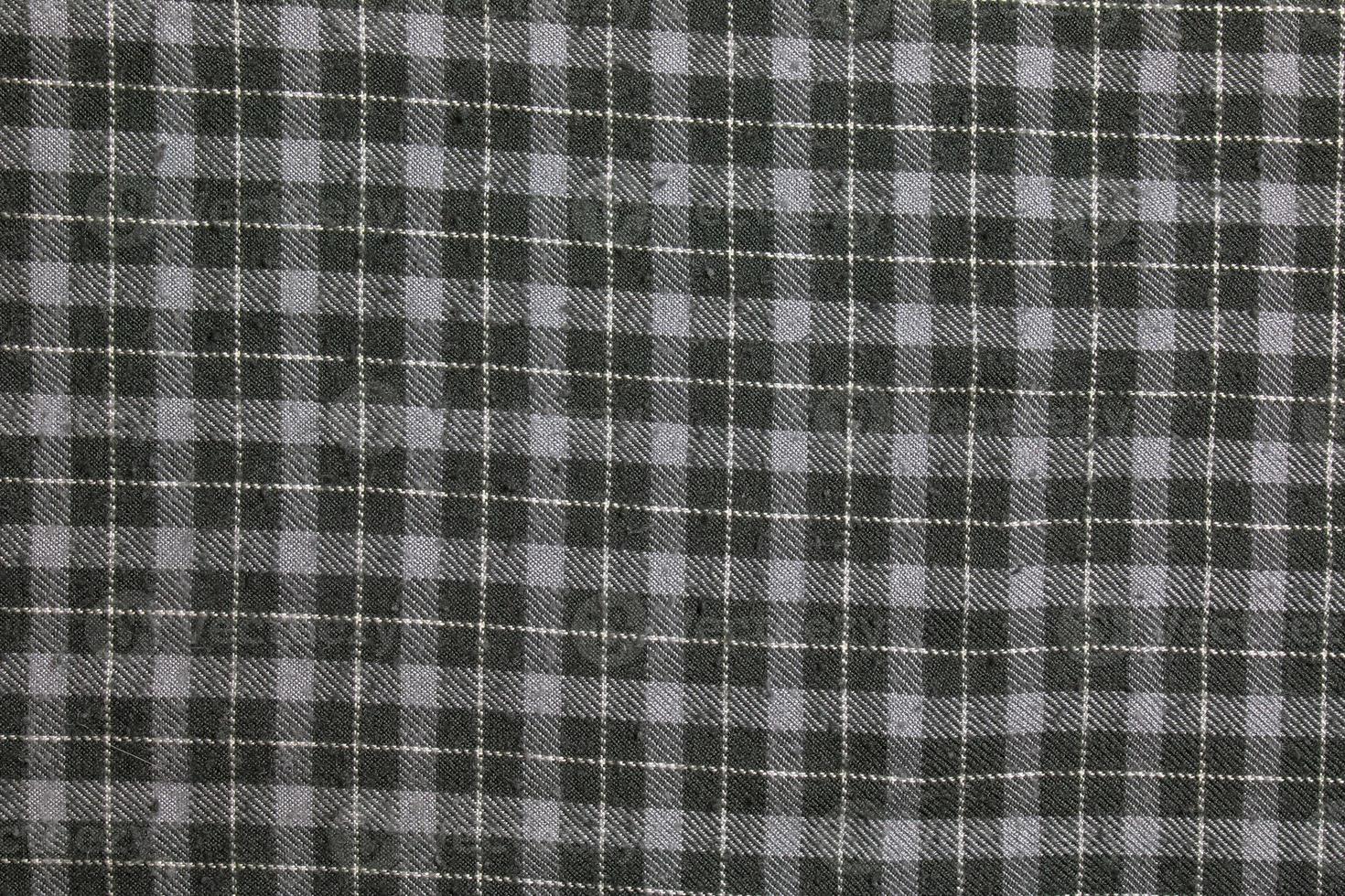 Texture of checkered gray, white wool. Checkered light gray textured fabric background closeup photo