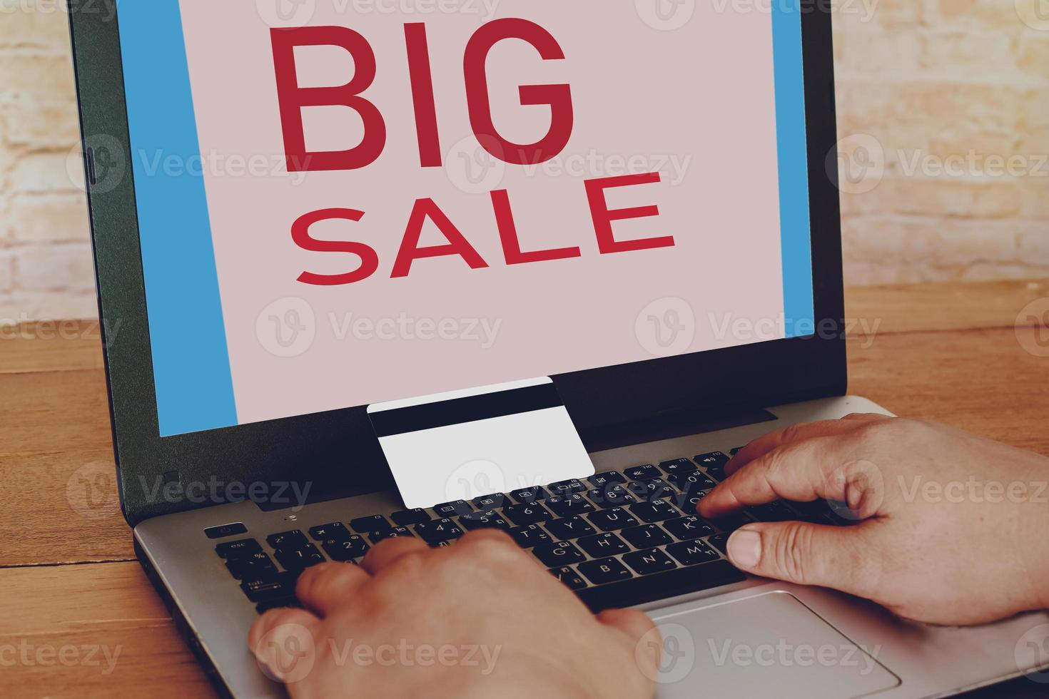 Hand Typing On Laptop Keyboard With Credit Card, Big sale Shopping. photo