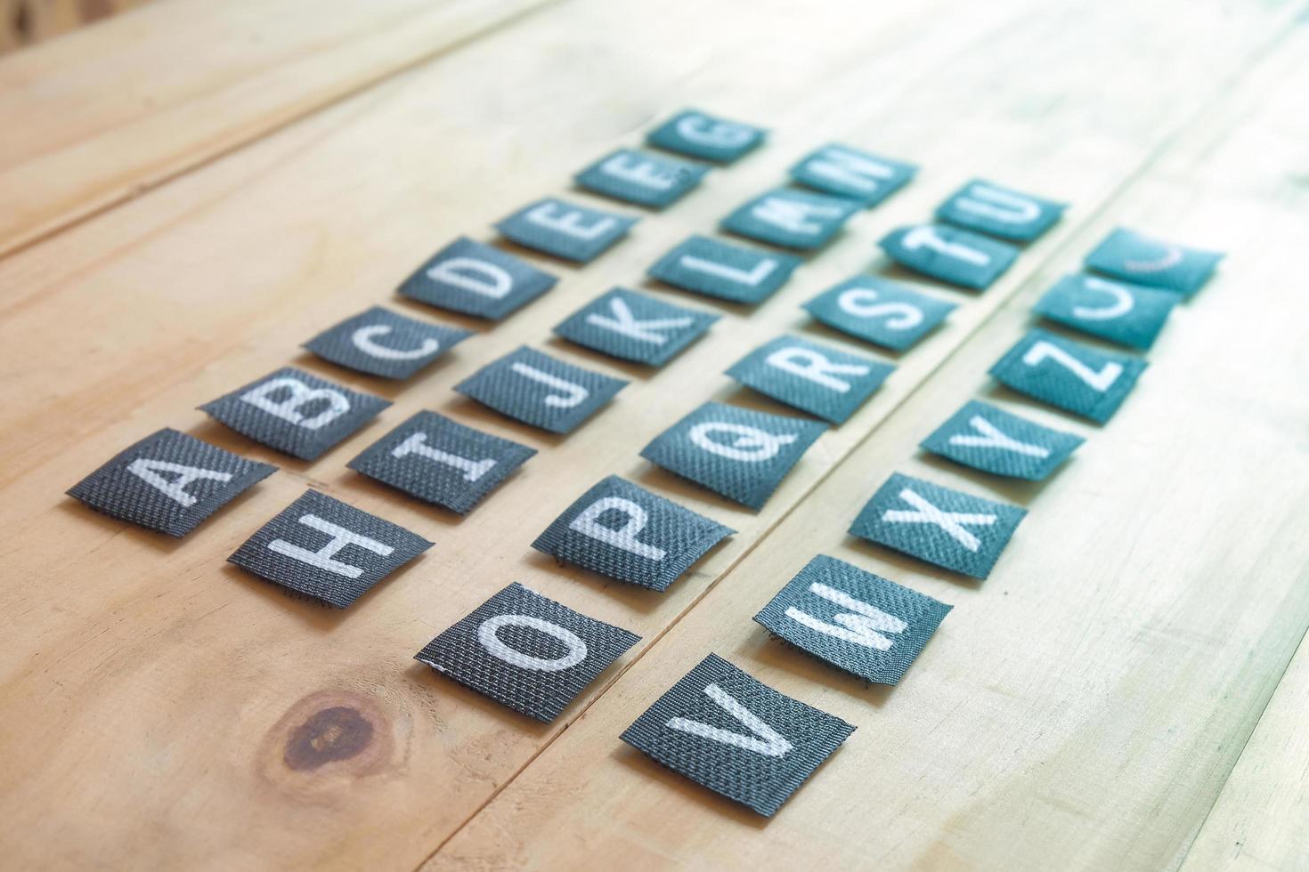 English alphabet letters on wood table. photo