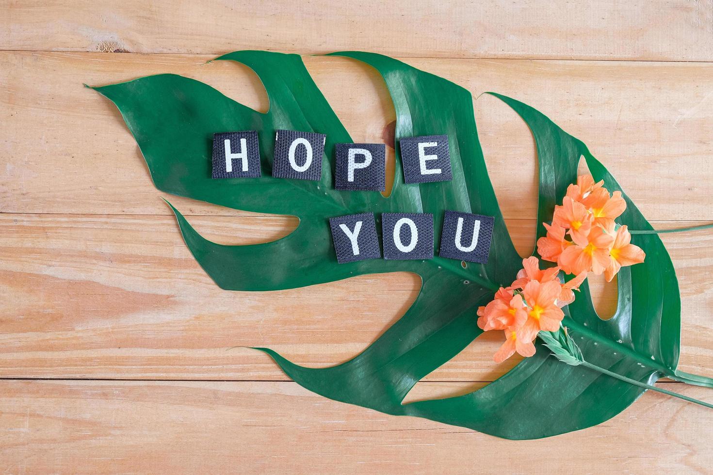 Hope you tag with flower on wood table. photo