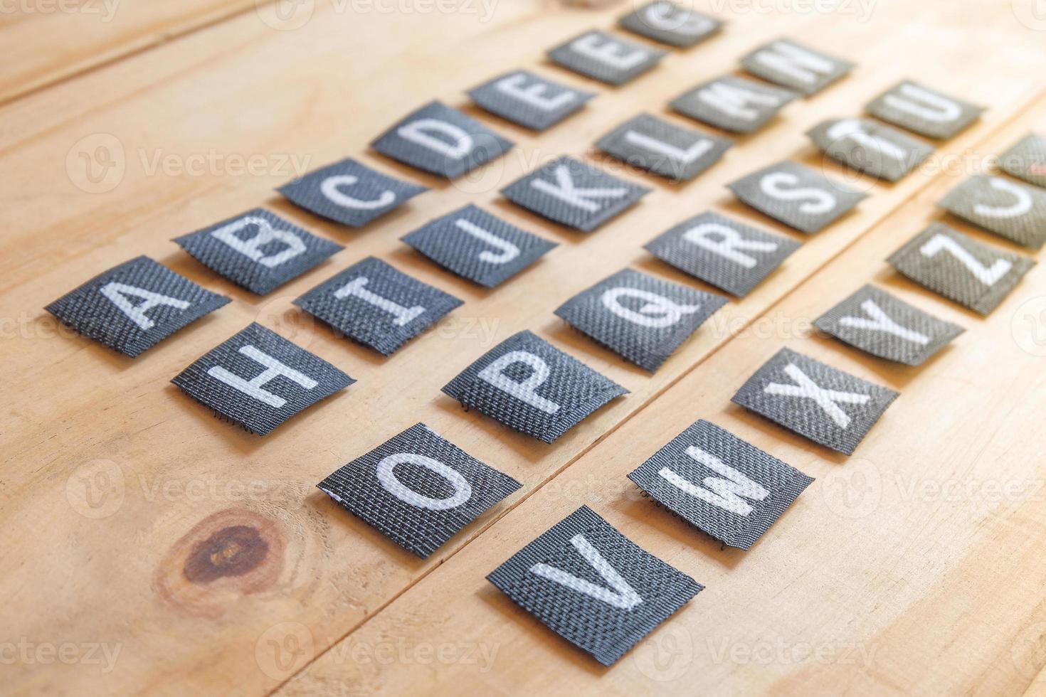 English alphabet letters on wood table. photo