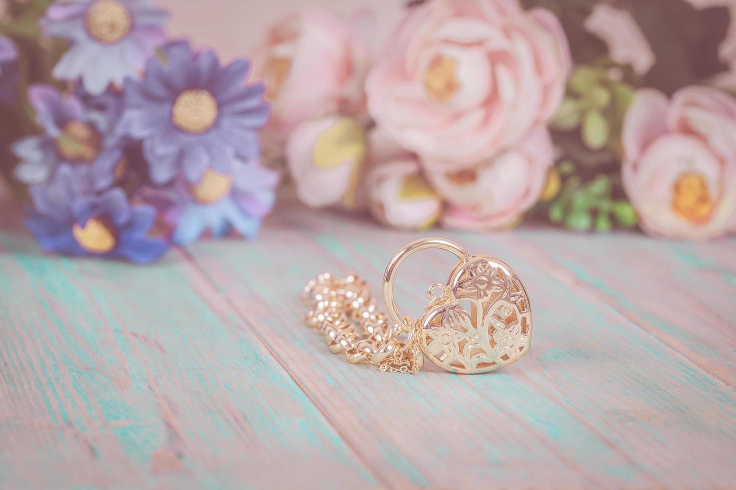 gold bracelet with heart on color wood photo