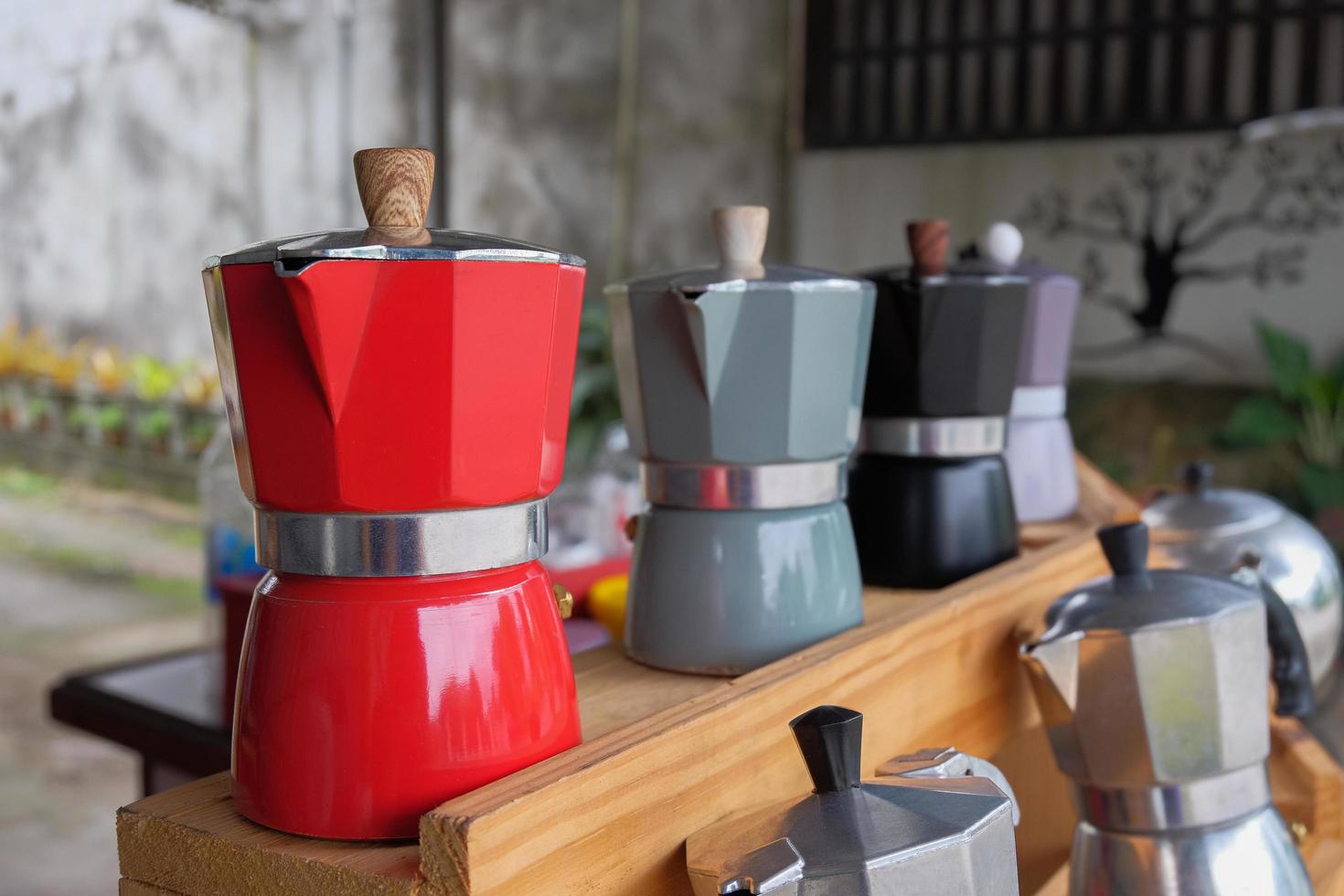 Aluminum italian espresso coffee pot on a wood table.Moka pot. photo