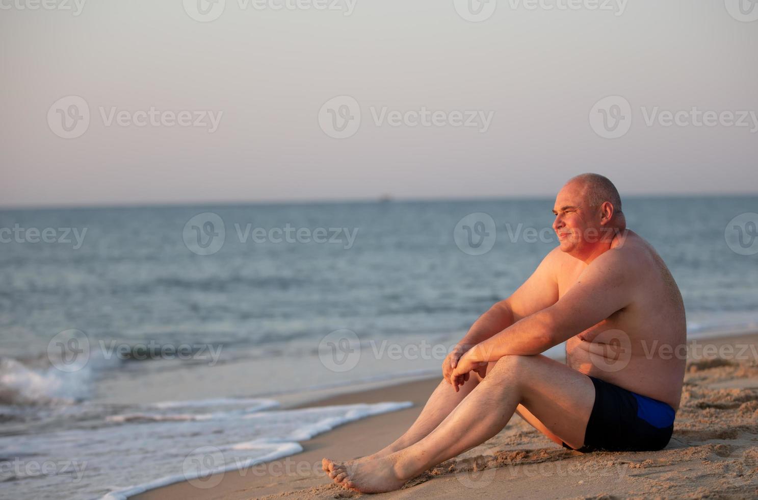 Middle-aged adult man by the sea. photo