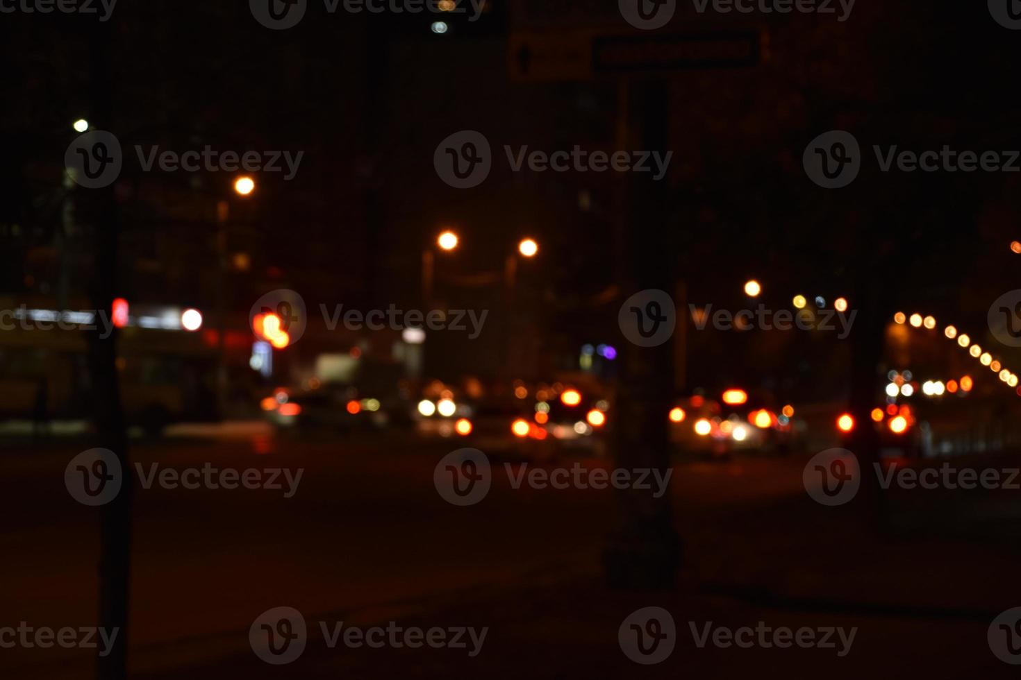 Multicolored lights of the night city. Glowing city road at night. photo