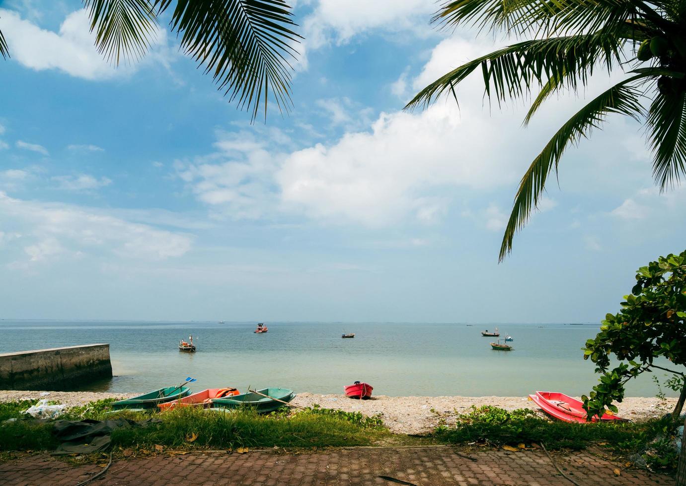 landscape view Small fishing boat parked on the coast of the sea. after fishing of fishermen in a small village It is a small local fishery. Blue sky white cloud clear weather Bang Pra Beach Chonburi photo