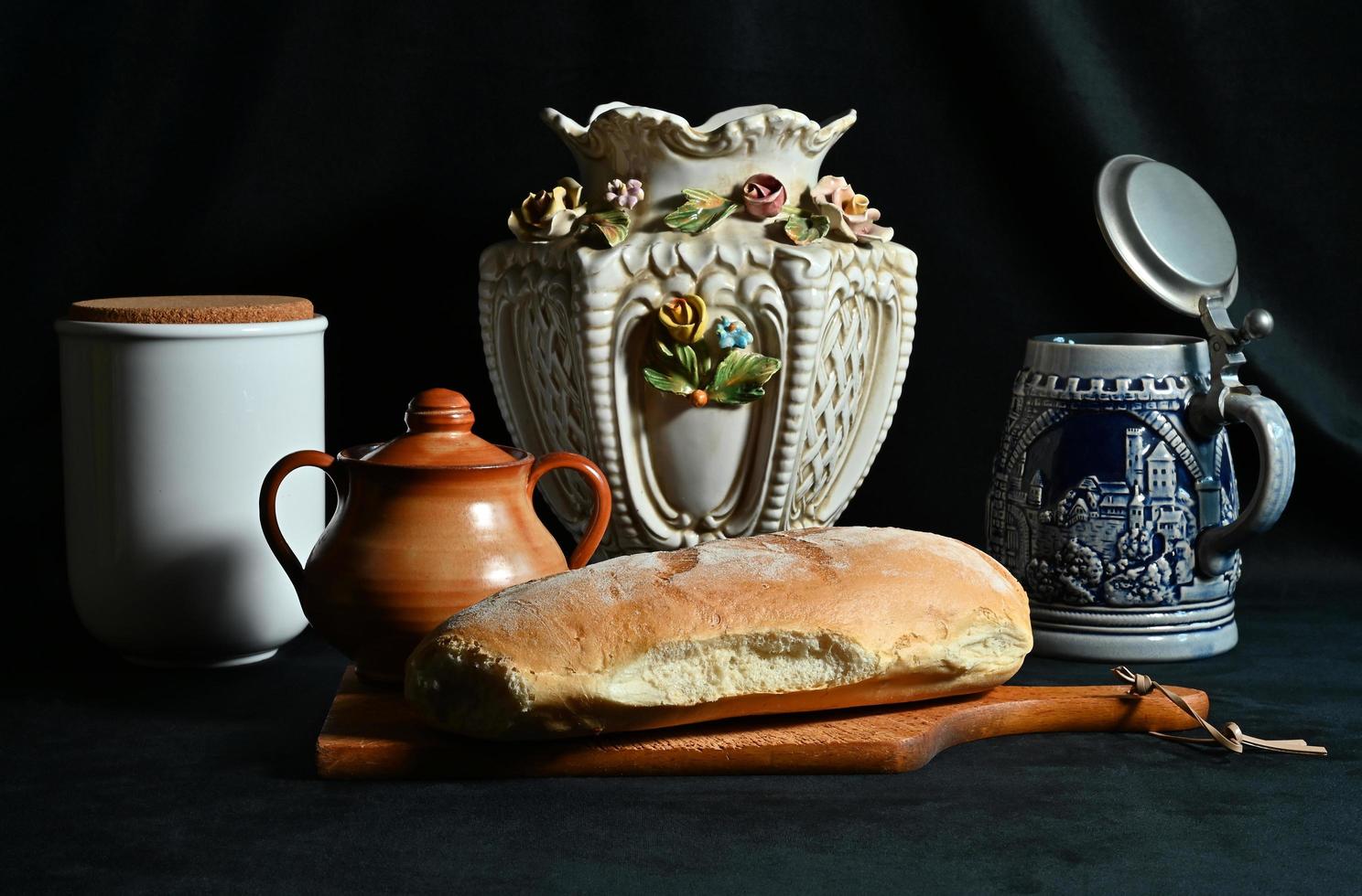 Cervia, Ravenna province, Italy February 22, 2023.  Still Life in artificial light with Tuscan bread, some pots and a beer mug. photo