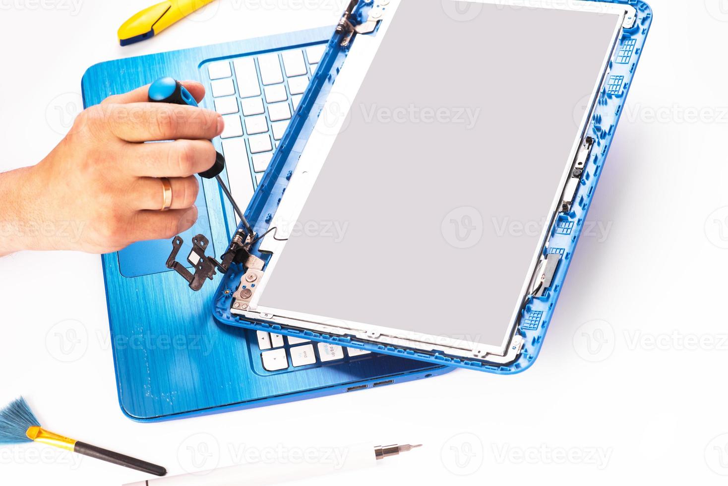 The engineer repairs blue laptop, pc, computer and the screen. laptop