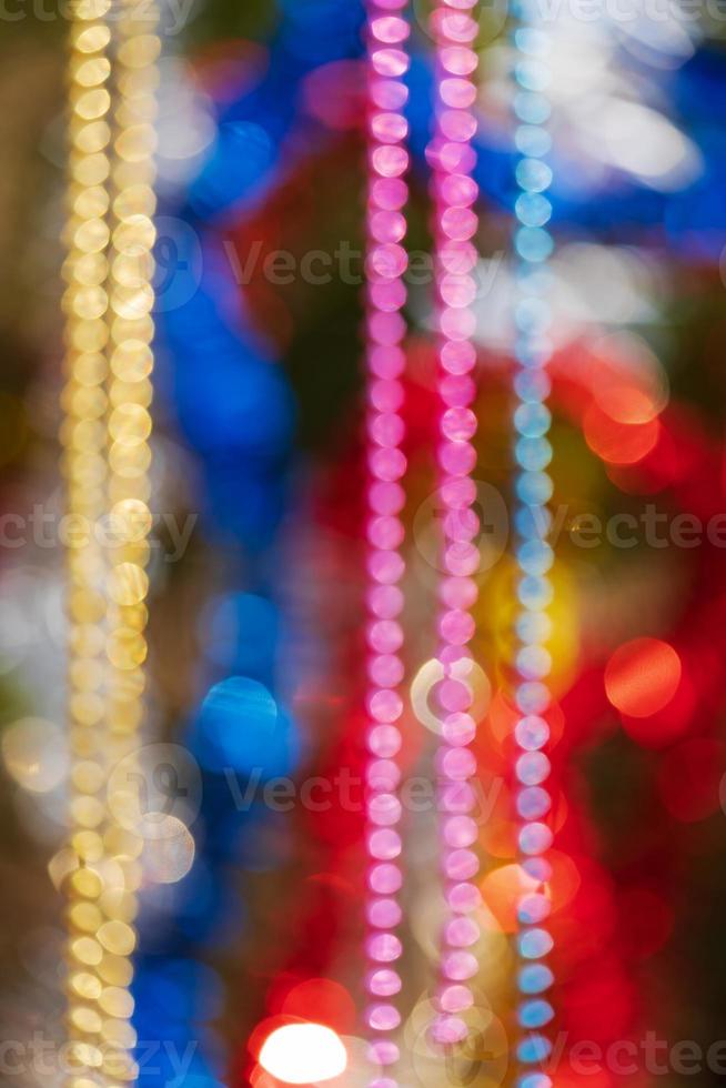 Colorful Christmas ornament decorations. Defocused abstract blurry bokeh background of balls, beads and tinsel photo
