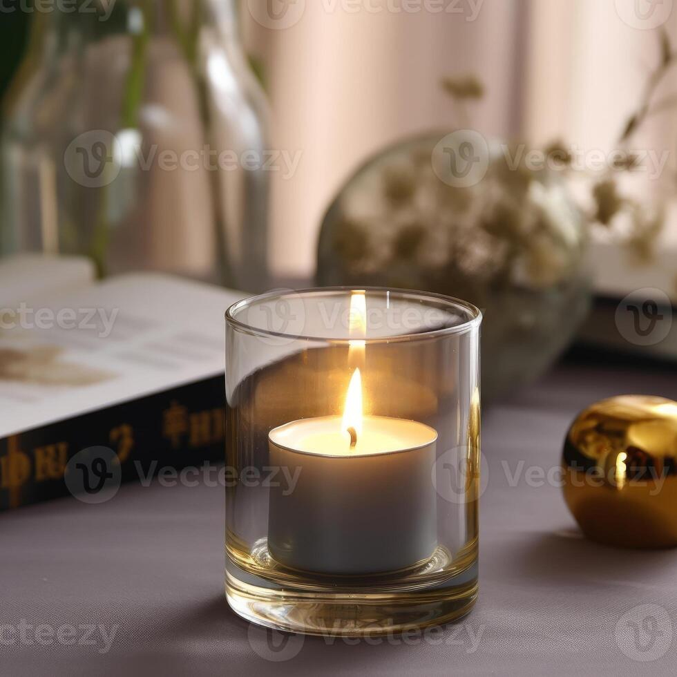A beautiful cylindrical candle glowing on glass photo