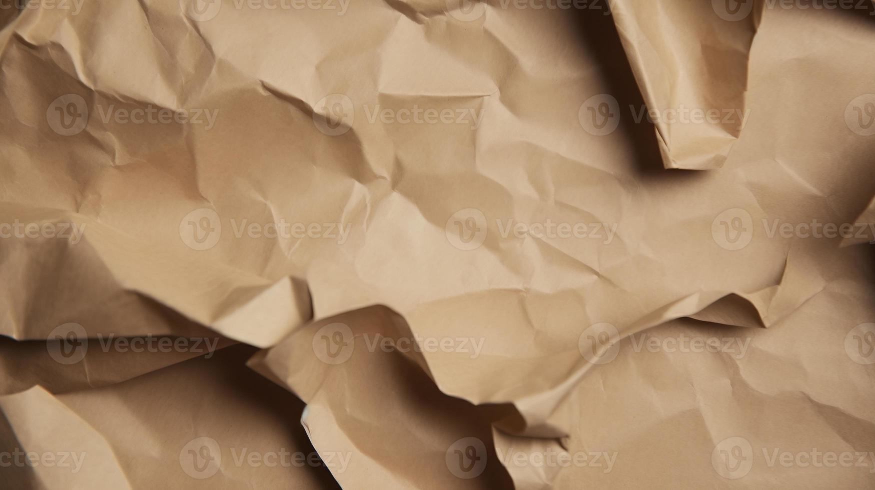 close up of crumpled brown paper texture background with copy space photo