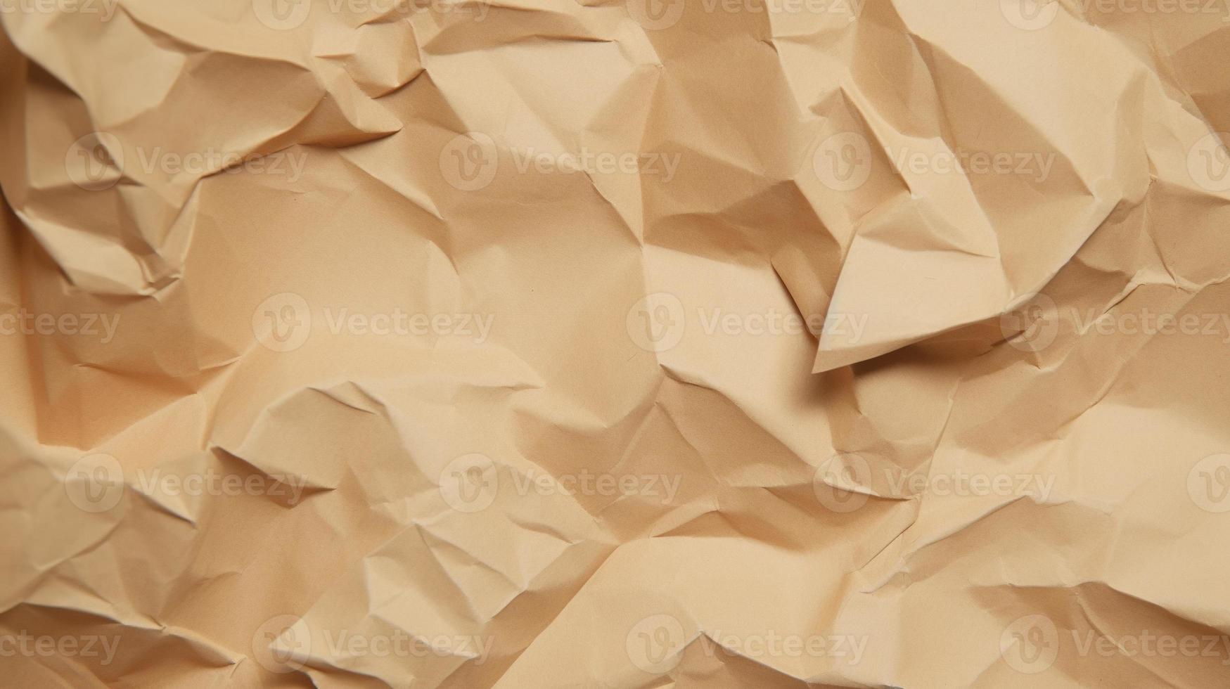 close up of crumpled brown paper texture background with copy space photo