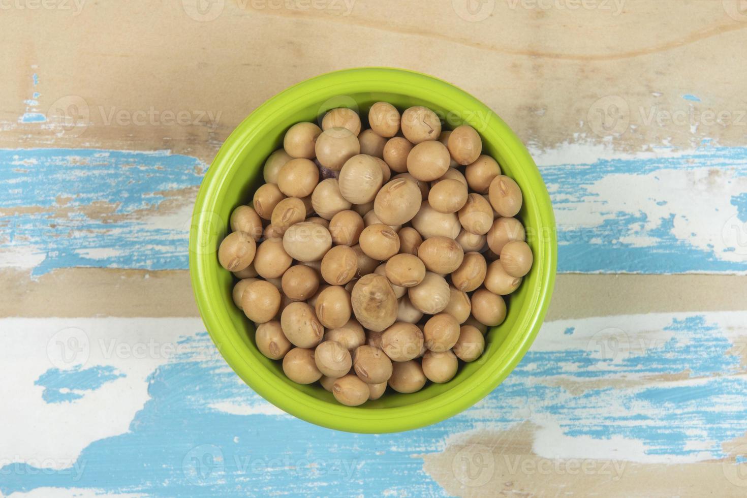 bowl with soy beans on blue rustic wooden table photo