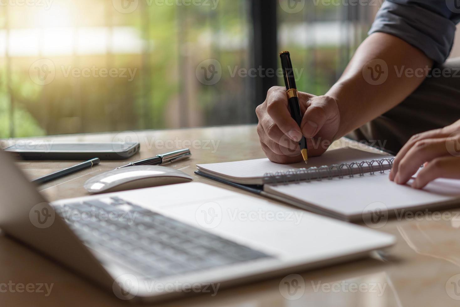 Businessperson reading and writing on book.education studying knowledge development and cognition learning concept. photo