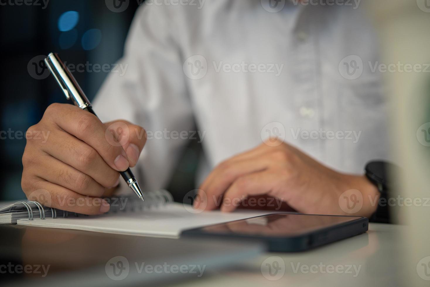 Businessperson reading and writing on book.education studying knowledge development and cognition learning concept. photo