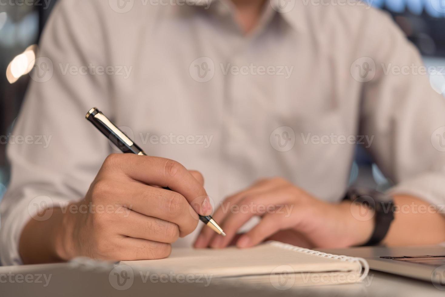 Businessperson reading and writing on book.education studying knowledge development and cognition learning concept. photo