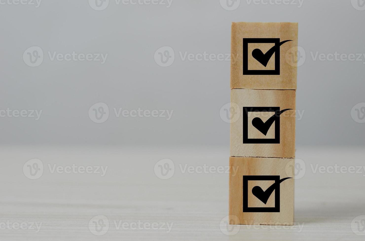 Checklist concept, wooden blocks cubes with icons.Corporate regulatory and compliance. Quality control management.ISO certification, service quality warranty. photo