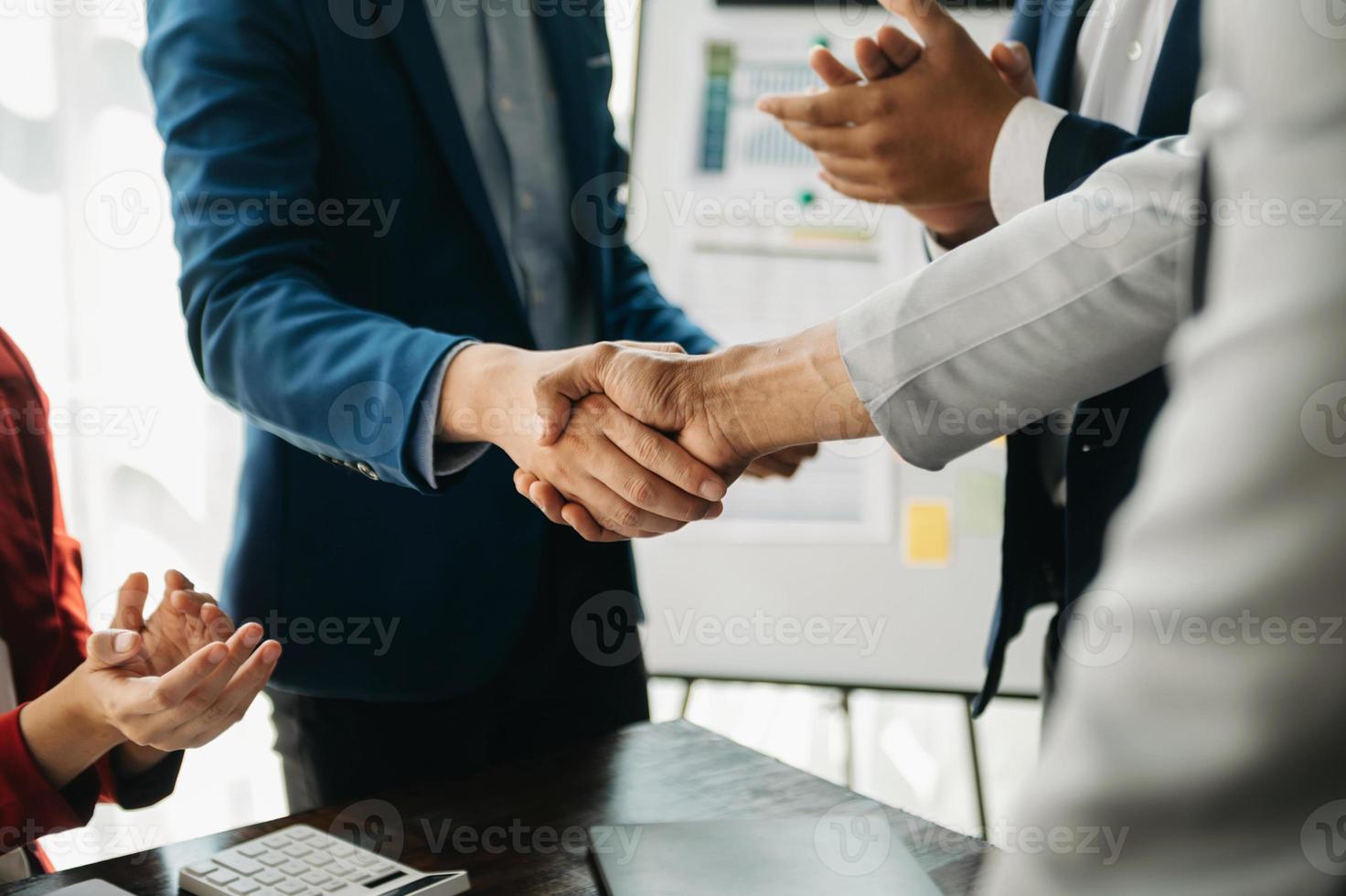 business people shaking hands during a meeting in office photo