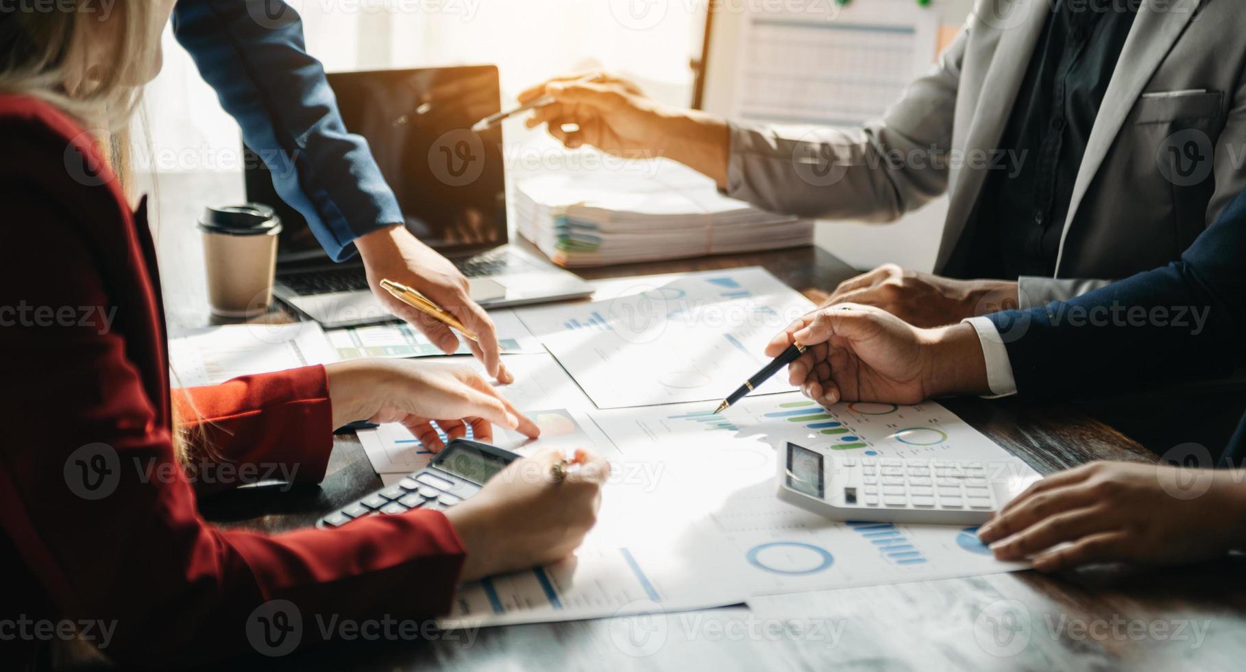 Business documents on office table with smart phone and calculator digital tablet and graph business with social network diagram and two colleagues discussing data working in the office photo