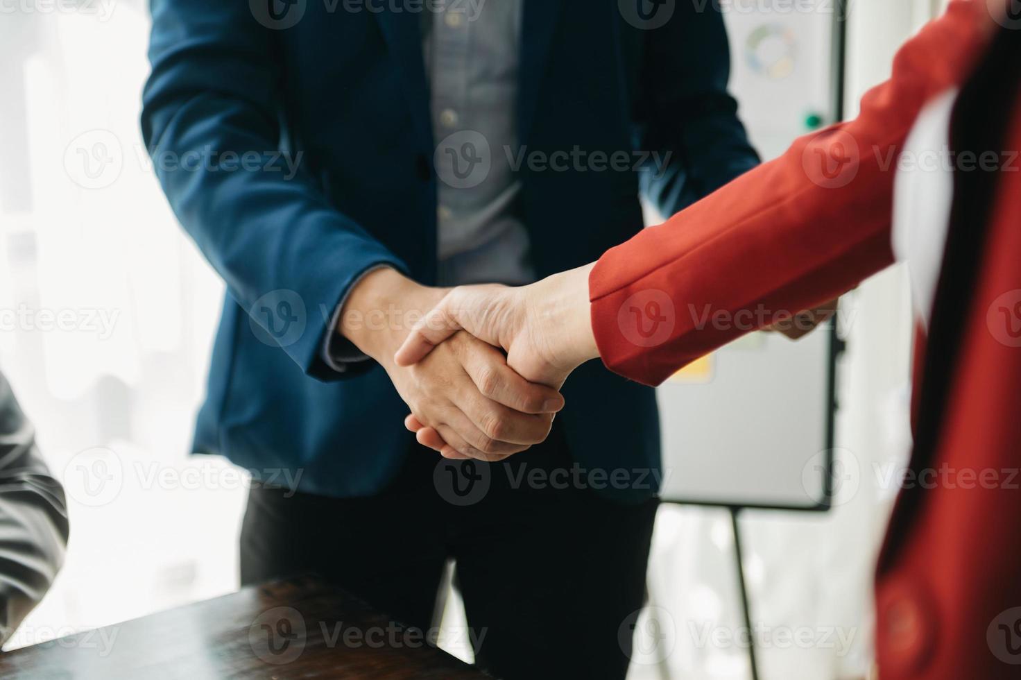 business people shaking hands during a meeting in office photo