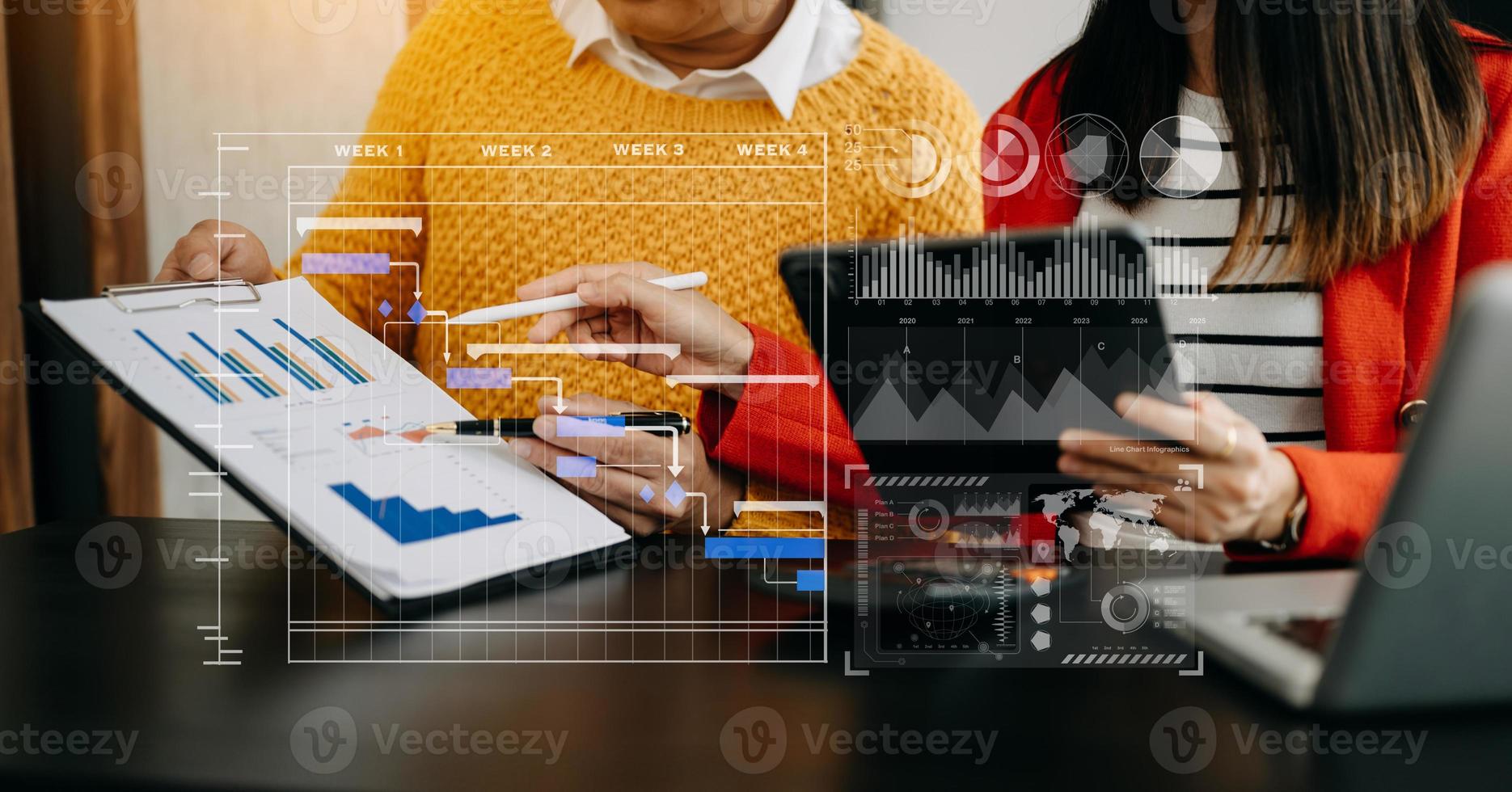 Businessman hand Project manager working and update tasks and Gantt chart scheduling virtual diagram.with smart phone, tablet and laptop in office. photo
