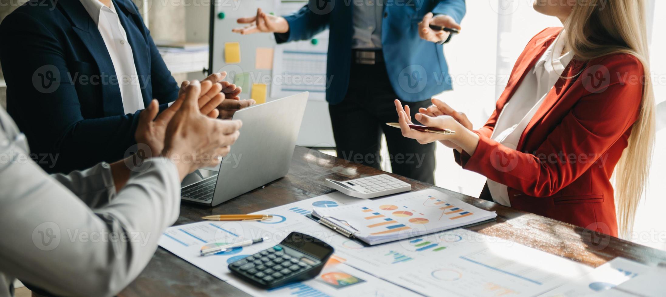 Businessman and team analyzing financial statement Finance task. with smart phone and laptop and  tablet. Wealth management concept photo