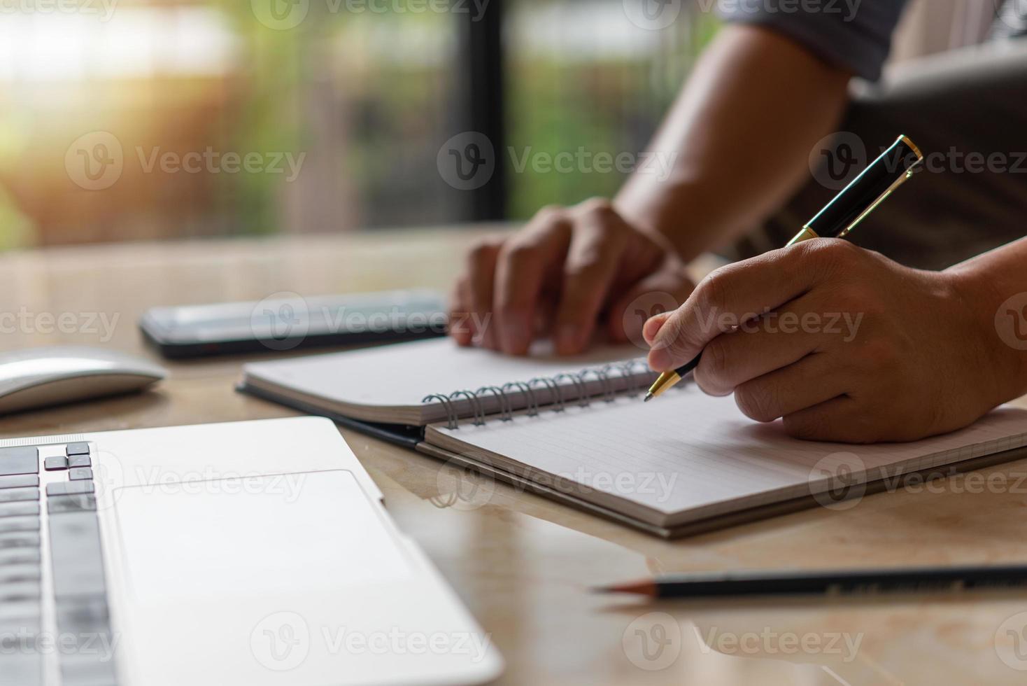 Businessperson reading and writing on book.education studying knowledge development and cognition learning concept. photo