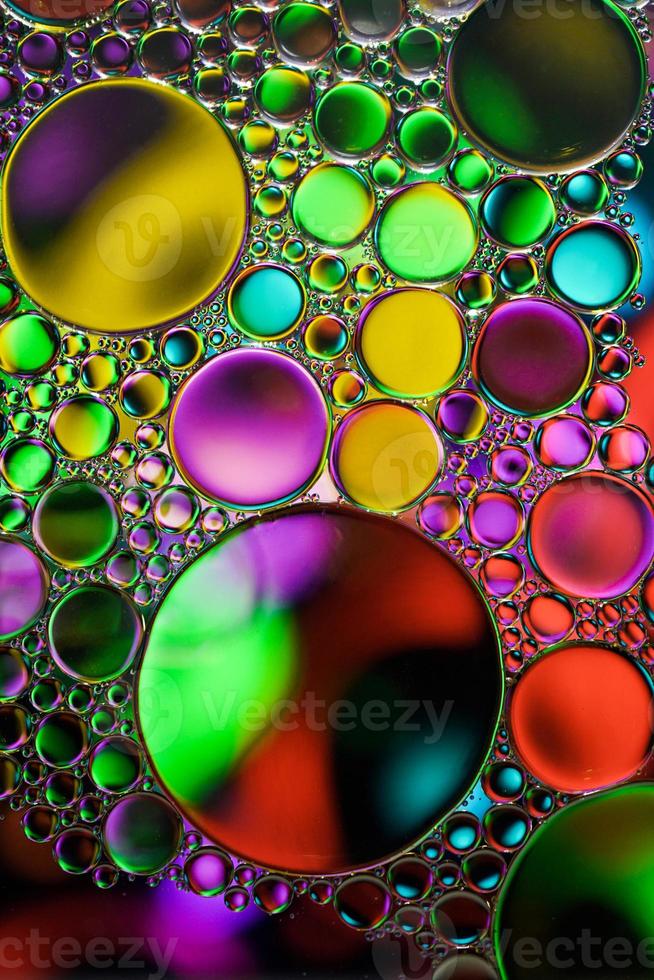 multi colored oil circles on the water, colorful background photo