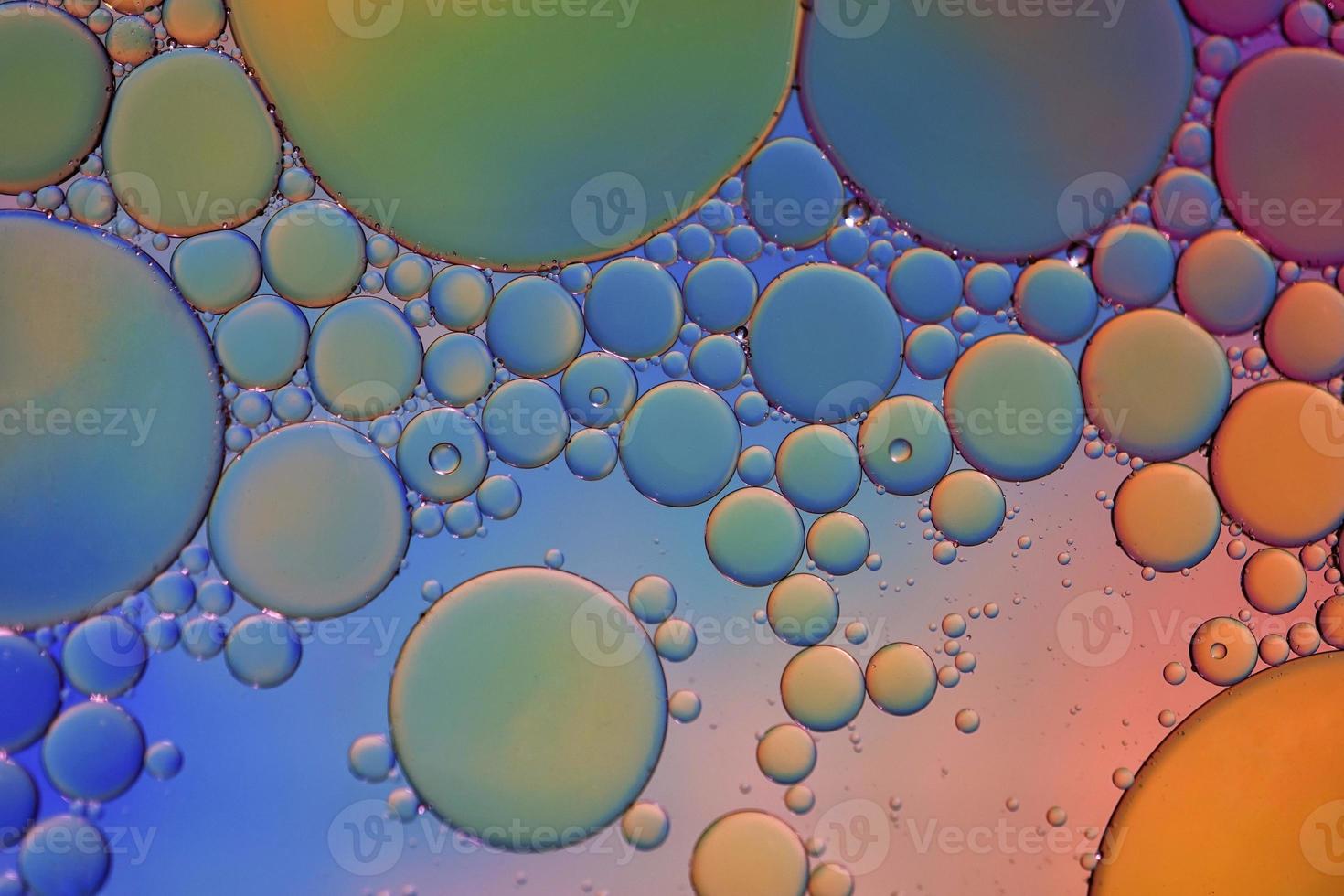 multi colored oil circles on the water, colorful background photo
