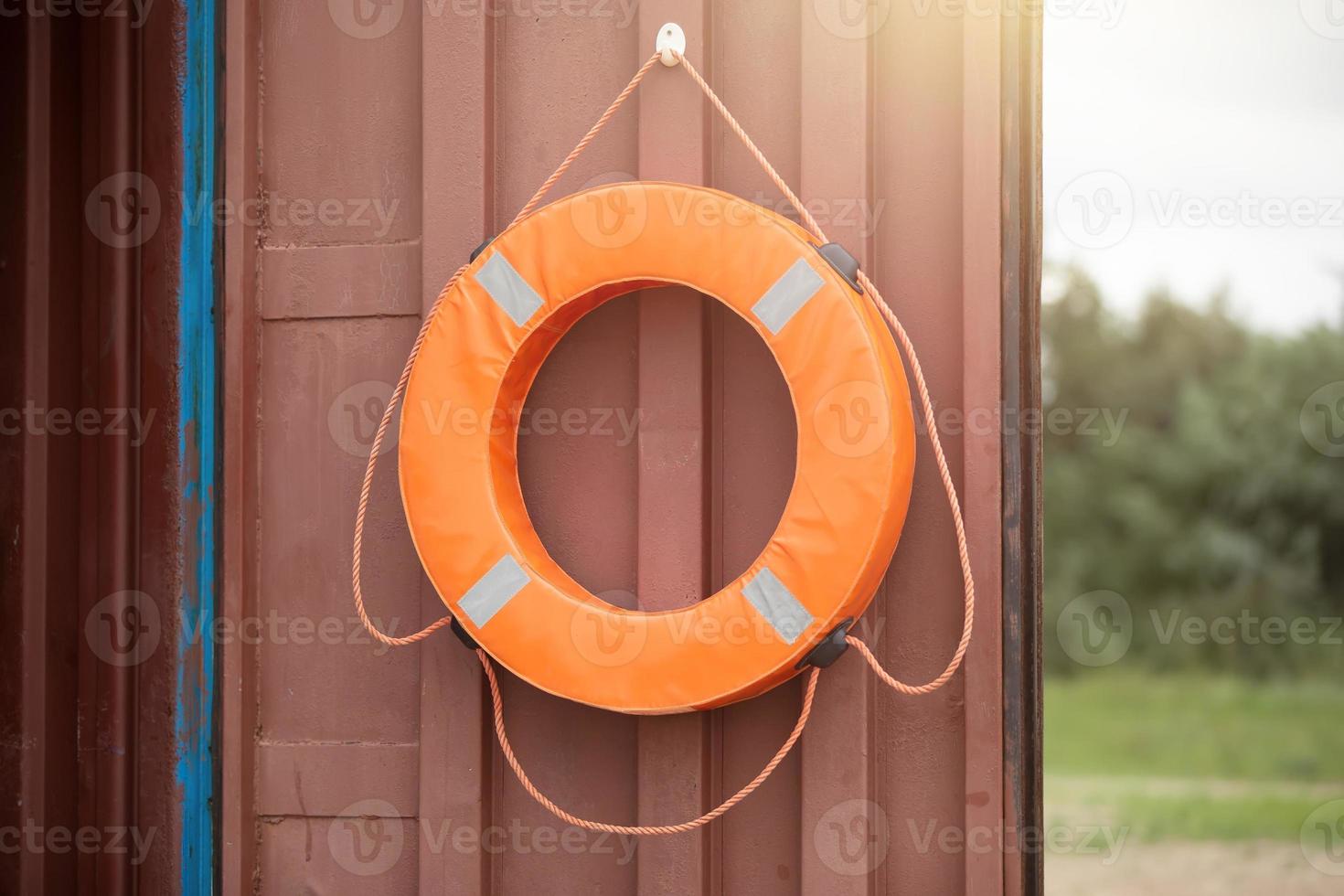 A life buoy is hanging on the door. photo