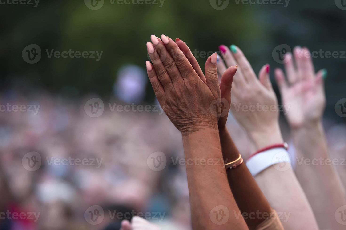 The black man raised his hands in protest. Social justice and peaceful protesting racial injustice. Black and white hands together against the background of a blurred crowd of people. photo