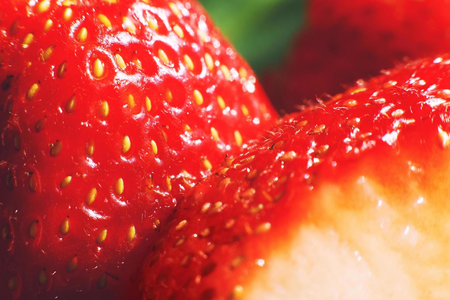 strawberry cut in half. strawberry core. half of a strawberry on a green background photo