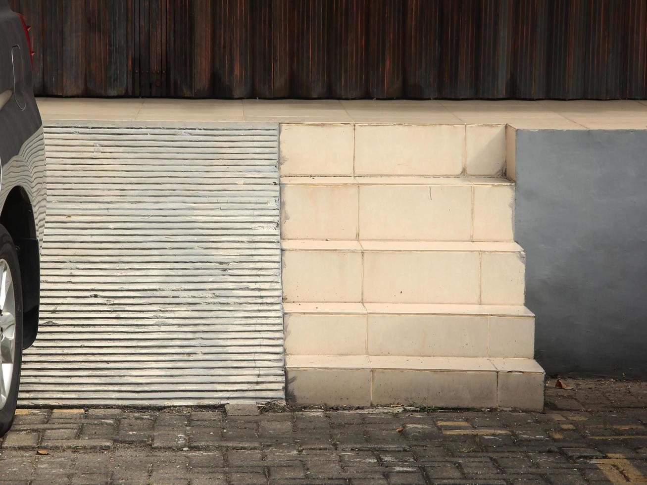 White stairs and slide outdoor in front of store from front view isolated on landscape template background with visible brick ground flooring. photo