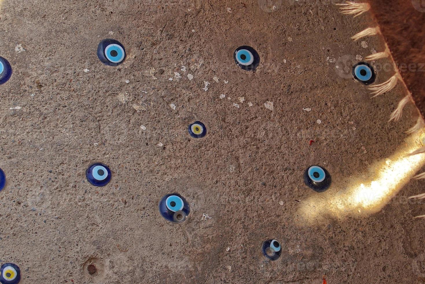 blue eye of prophet superstition protection symbol on pavement background in turkey photo