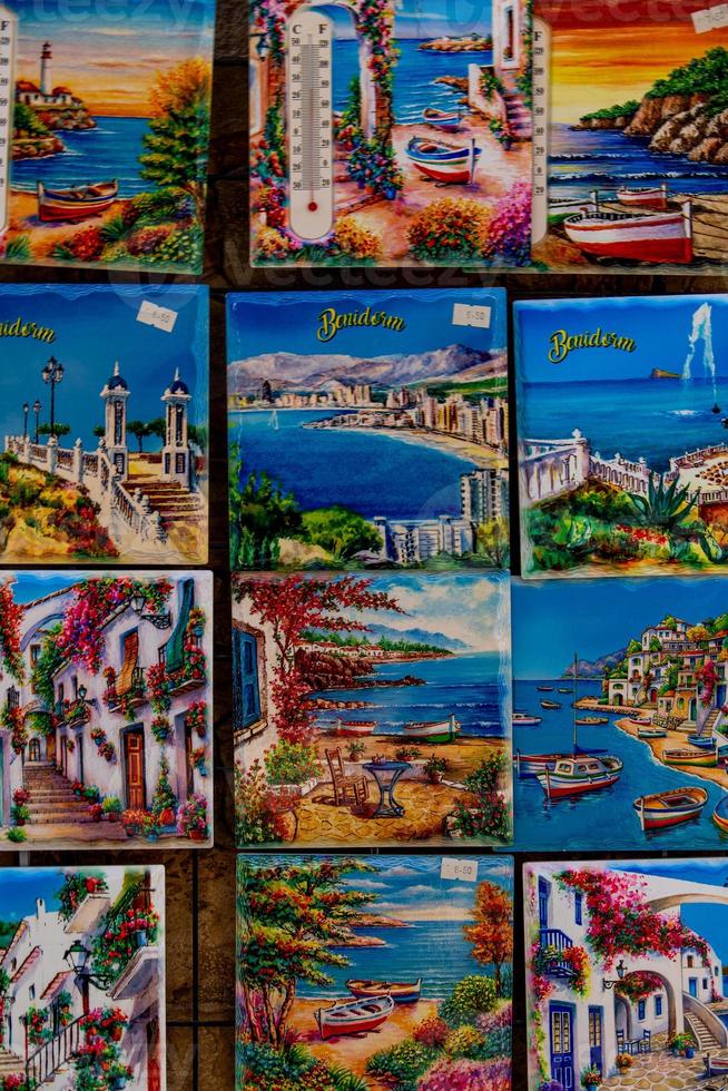 ceramic tiles souvenirs in a shop in the south of spain in a tourist town, colorful art crafts background photo