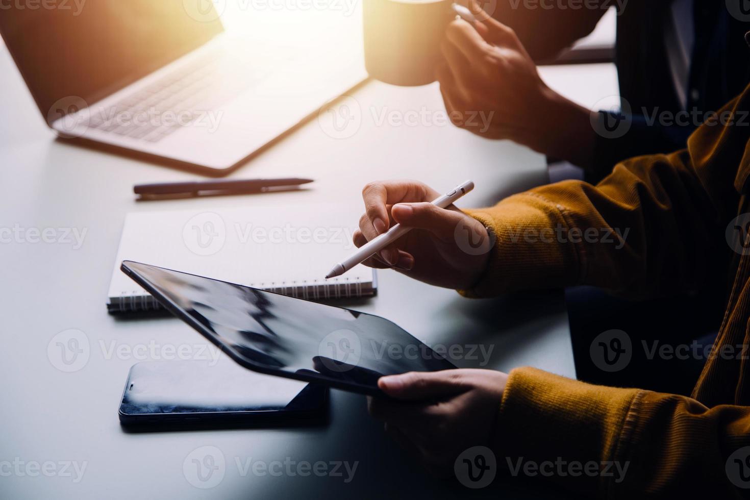 Group of confident business people point to graphs and charts to analyze market data, balance sheet, account, net profit to plan new sales strategies to increase production capacity. photo