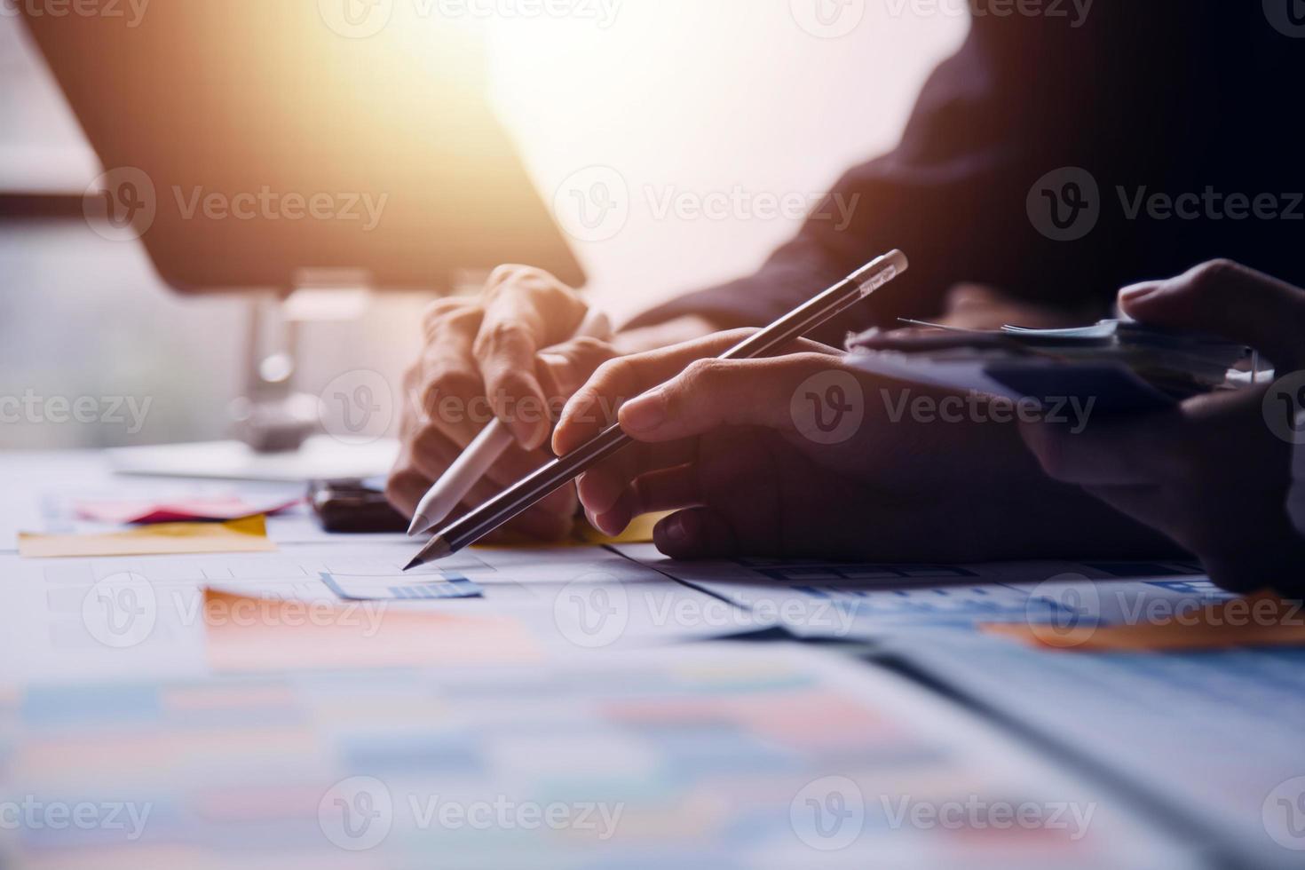 Close up ux developer and ui designer brainstorming about mobile app interface wireframe design on table with customer breif and color code at modern office.Creative digital development agency photo