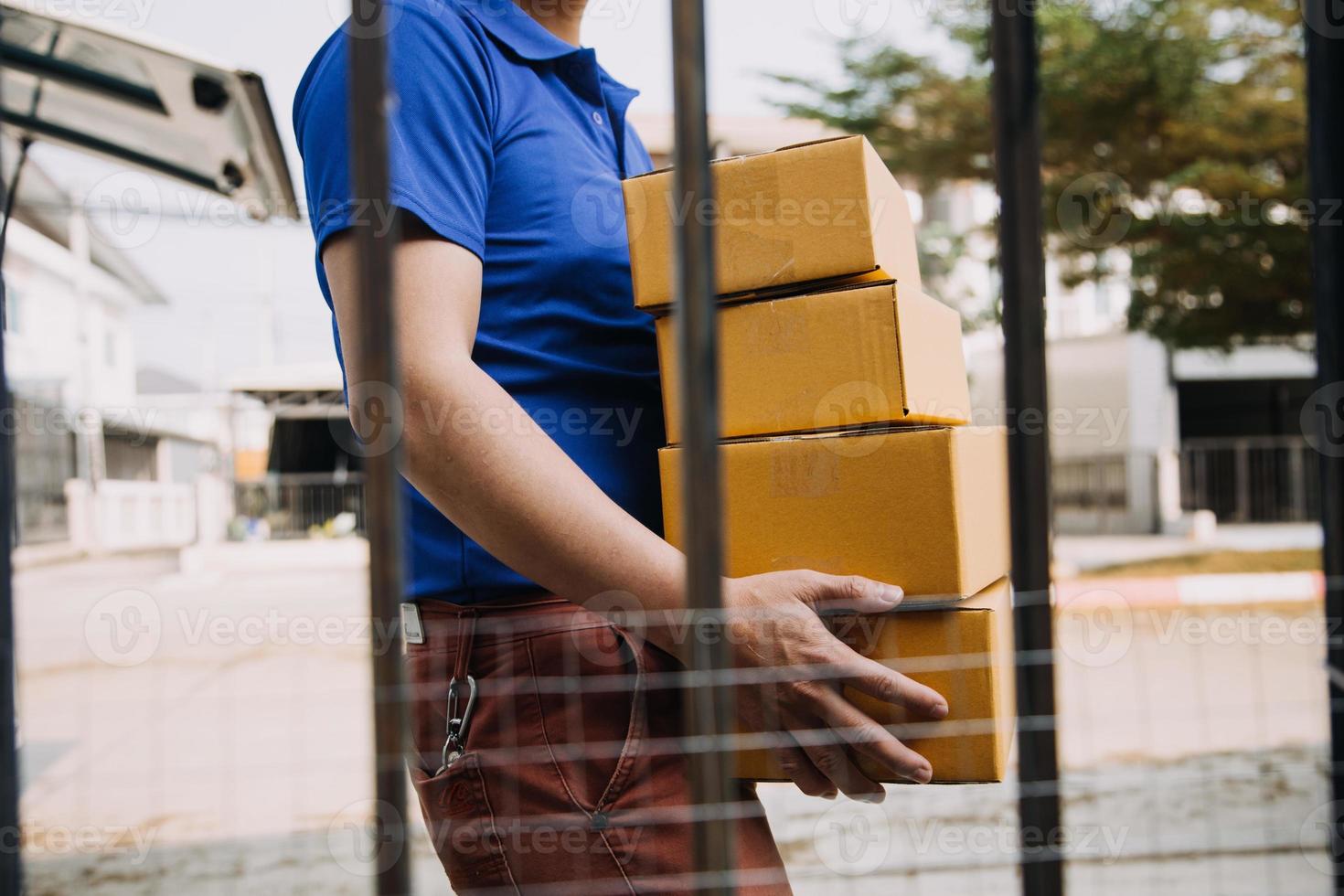 Startup SME small business entrepreneur of freelance Asian woman wearing apron using laptop and box to receive and review orders online to prepare to pack sell to customers, online sme business ideas. photo