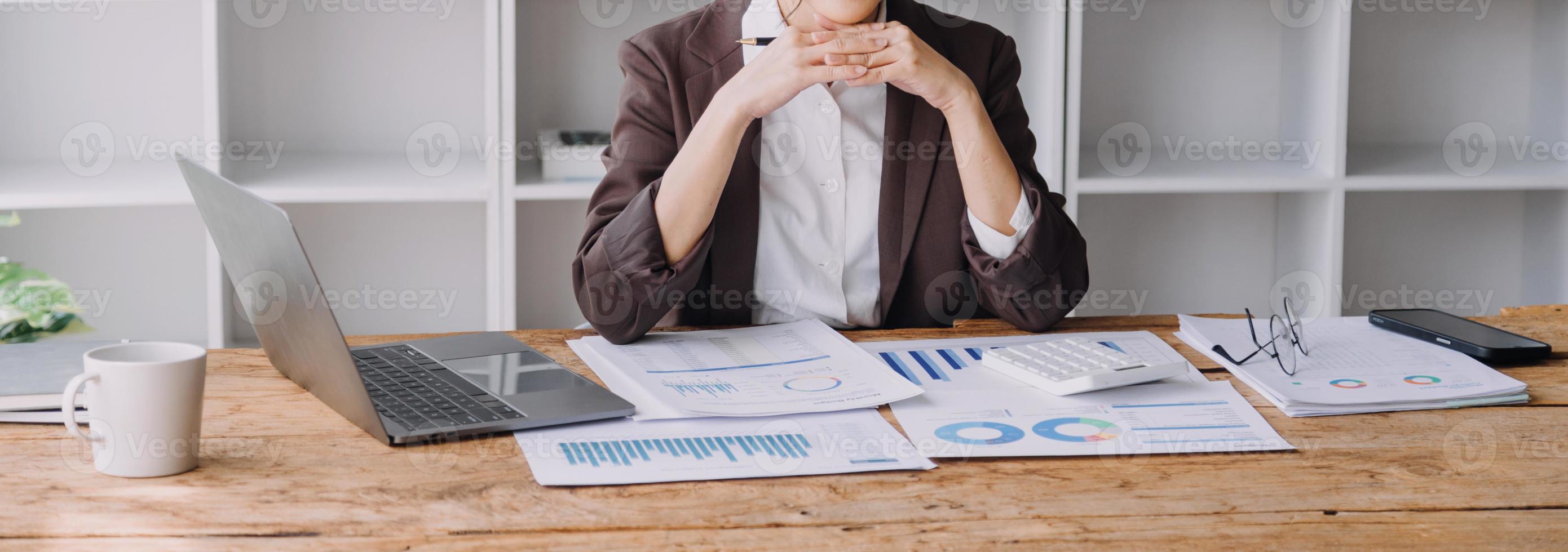 Businesswoman or accountant working Financial investment on calculator, calculate, analyze business and marketing growth on financial document data graph, Accounting, Economic, commercial concept. photo