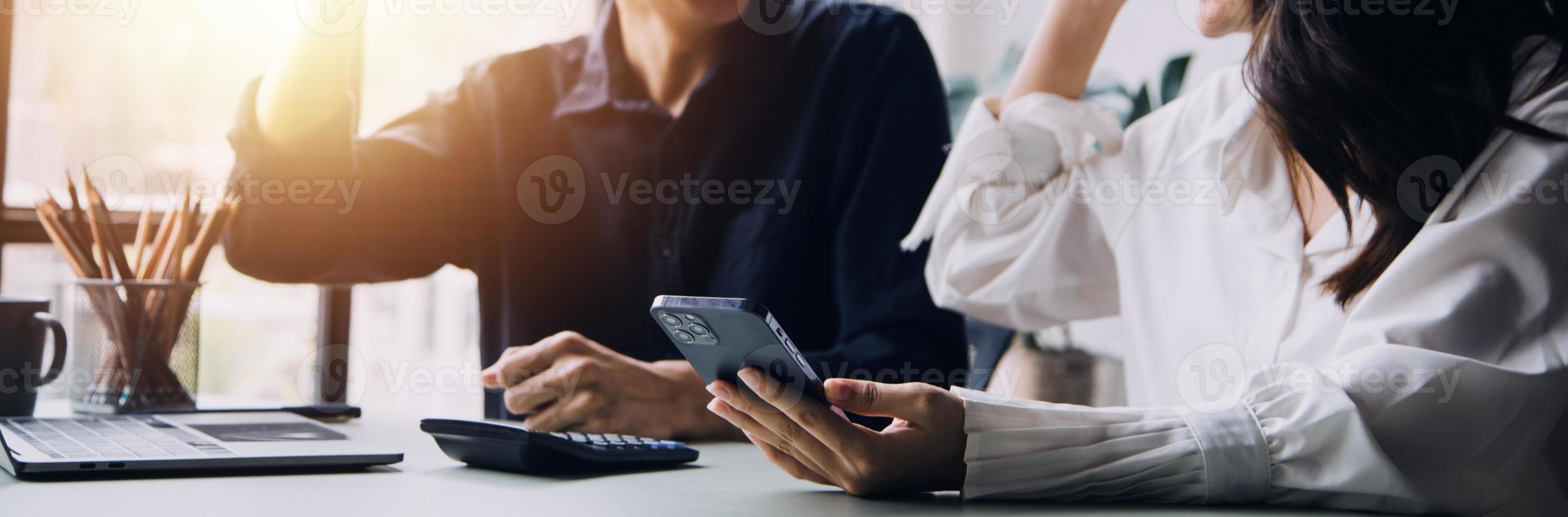 Group of confident business people point to graphs and charts to analyze market data, balance sheet, account, net profit to plan new sales strategies to increase production capacity. photo