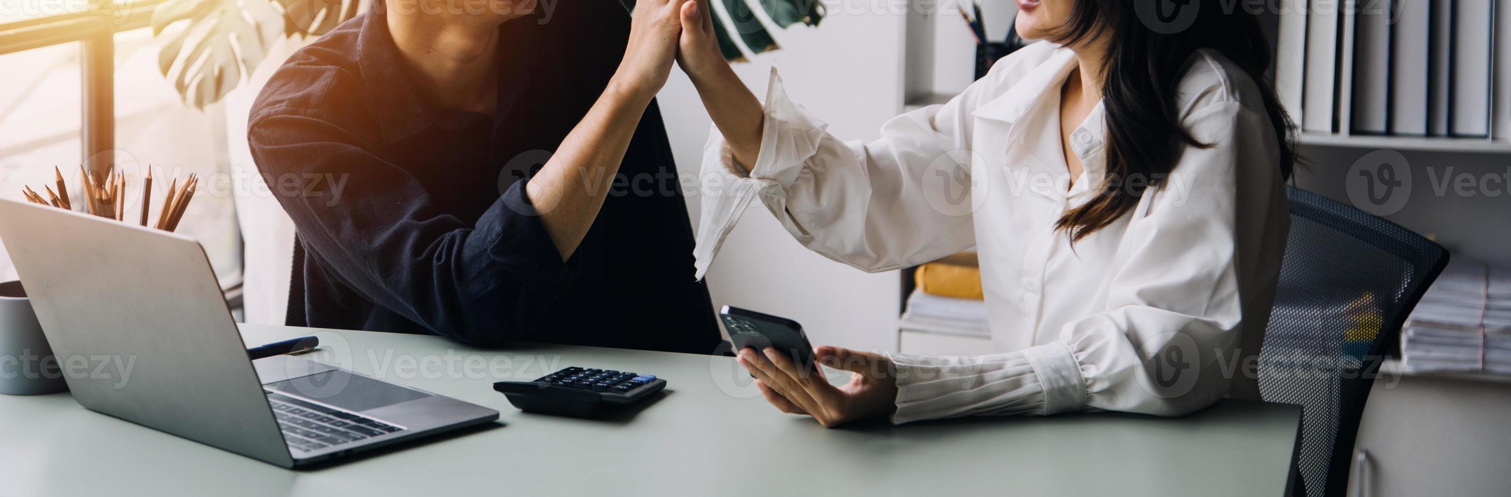 Group of confident business people point to graphs and charts to analyze market data, balance sheet, account, net profit to plan new sales strategies to increase production capacity. photo