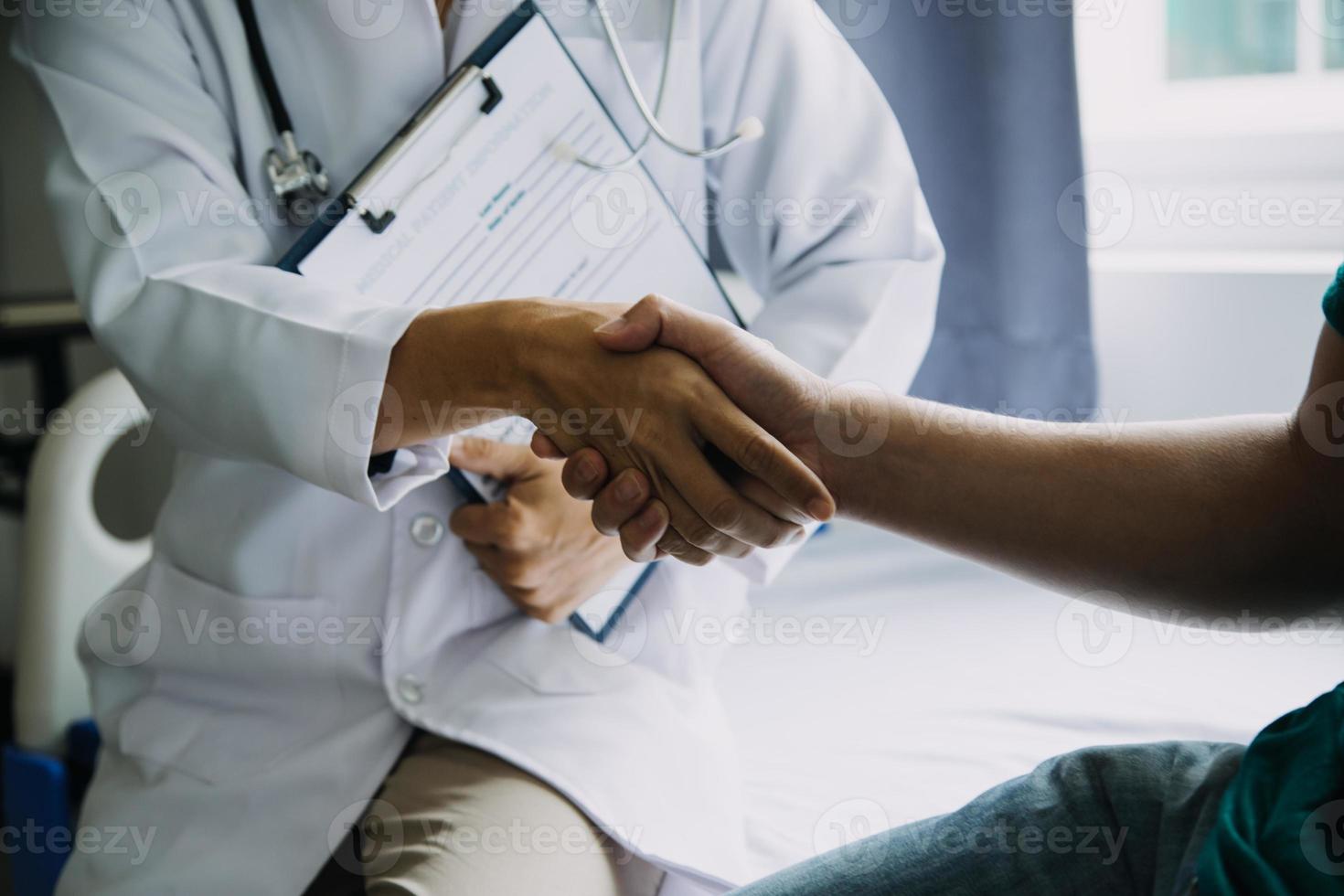 close up of patient and doctor taking notes photo