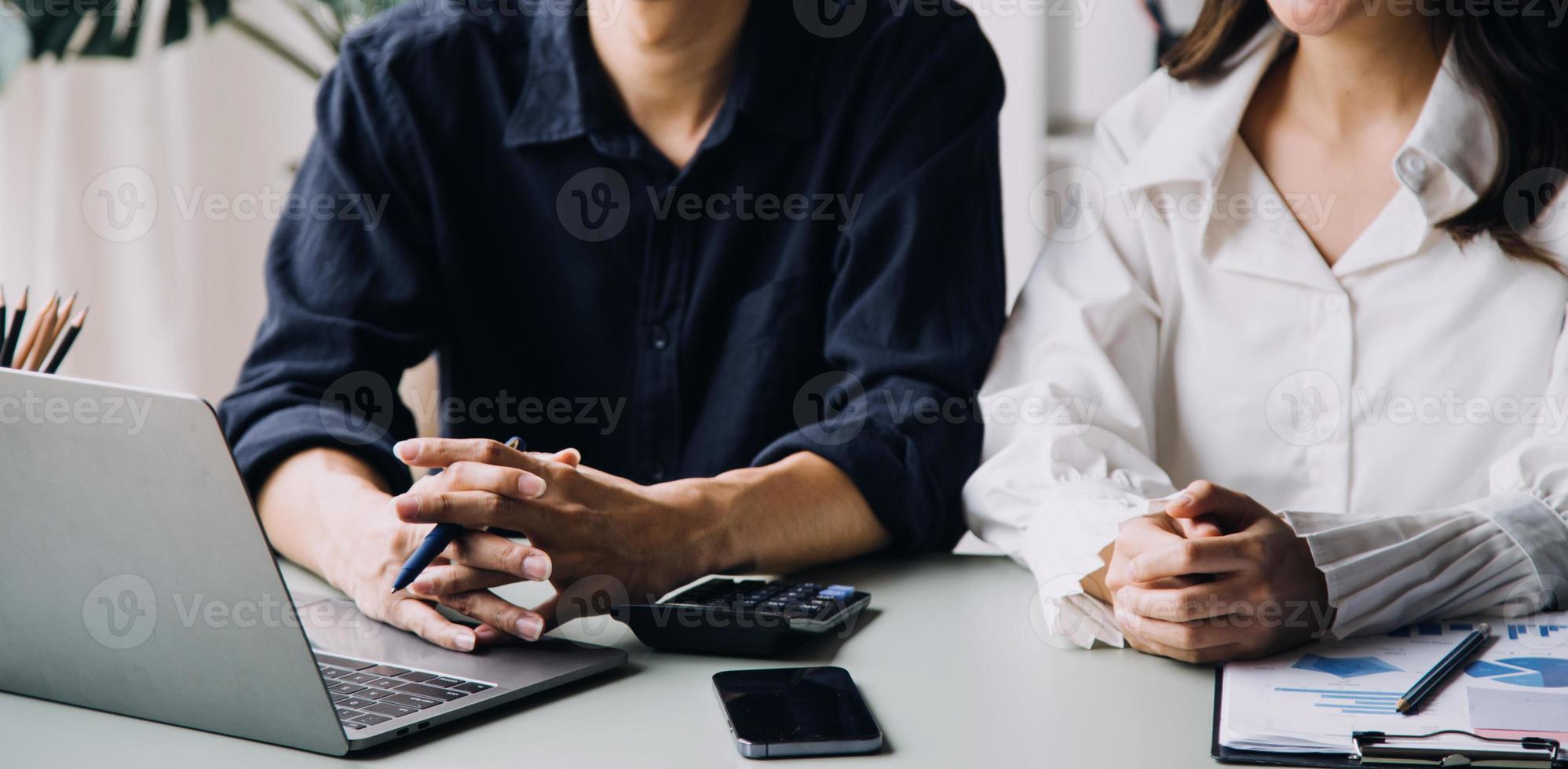 Group of confident business people point to graphs and charts to analyze market data, balance sheet, account, net profit to plan new sales strategies to increase production capacity. photo