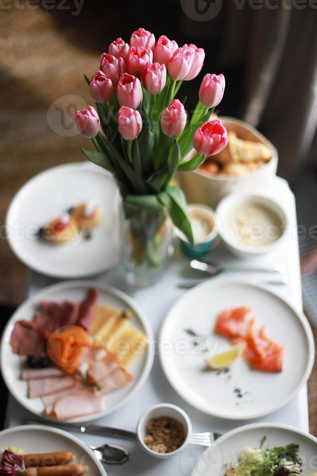 Food in the room, flowers on the table photo