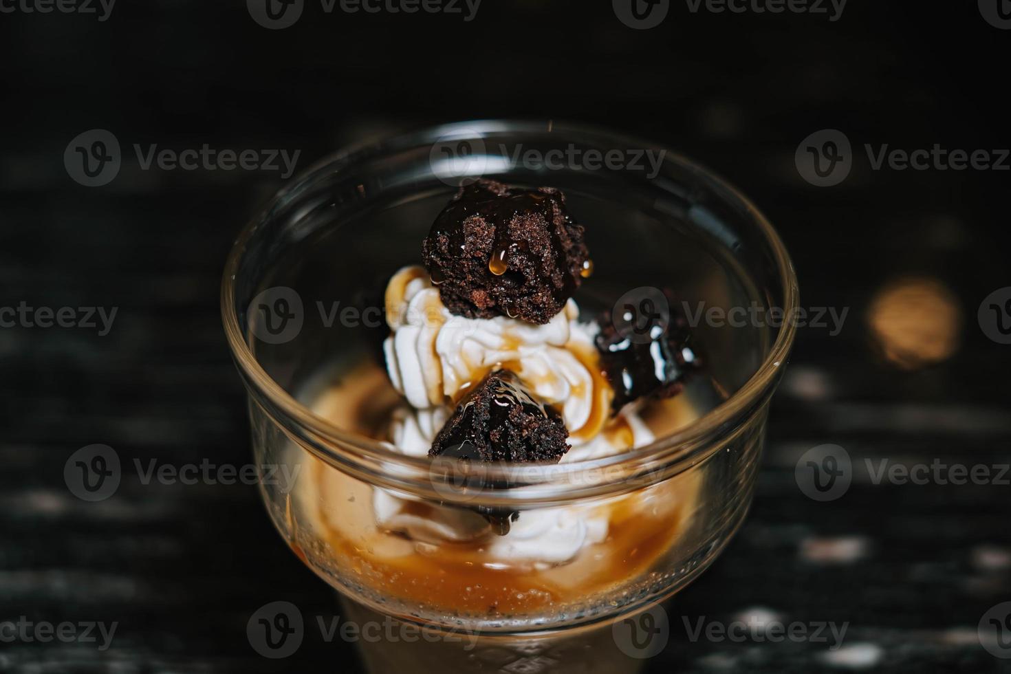 A glass of ice cream with coffee and additional brownies cake photo