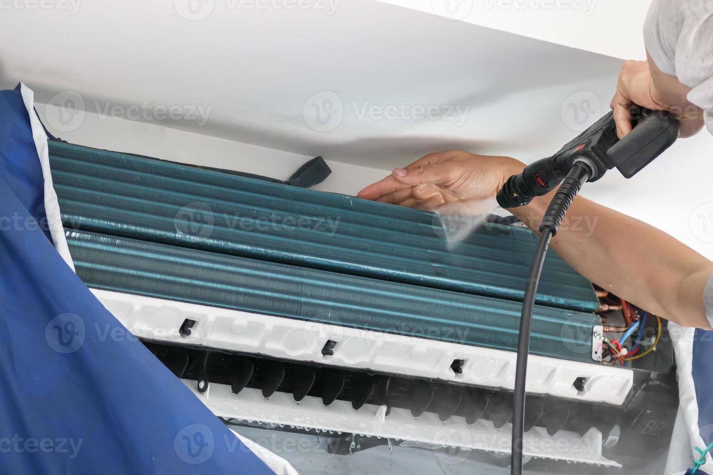 air conditioning cleaning service with water spray photo