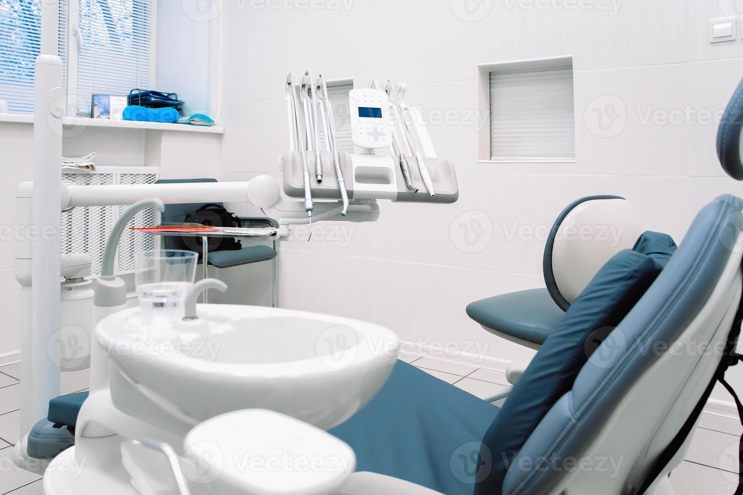 Close-up of dental equipment in dentistry clinic. Workplace and tools of dentists. Dental chair and surgical instruments photo