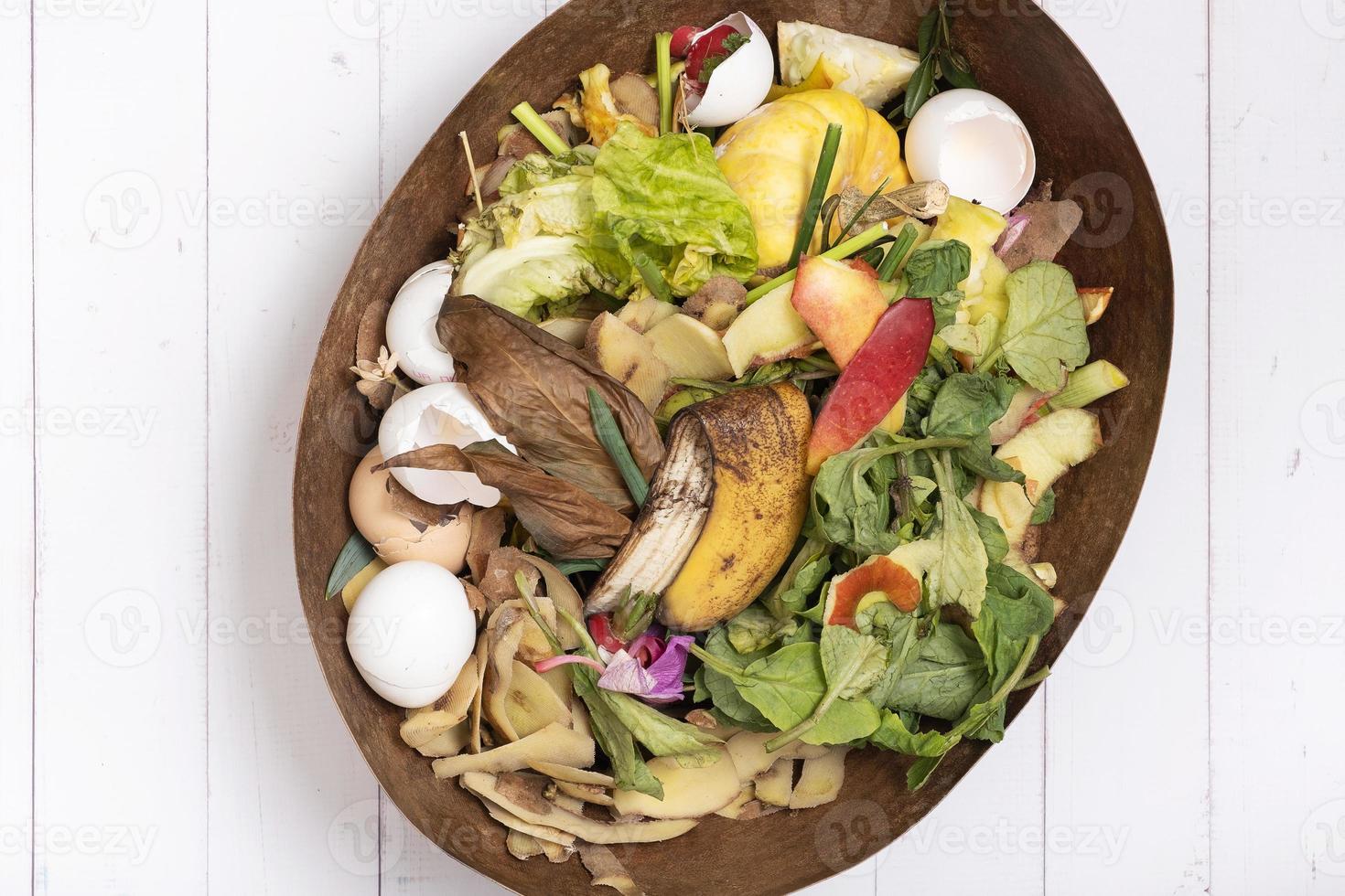 Organic garbage for compost on a wooden background. Composting concept flat lay, top view photo