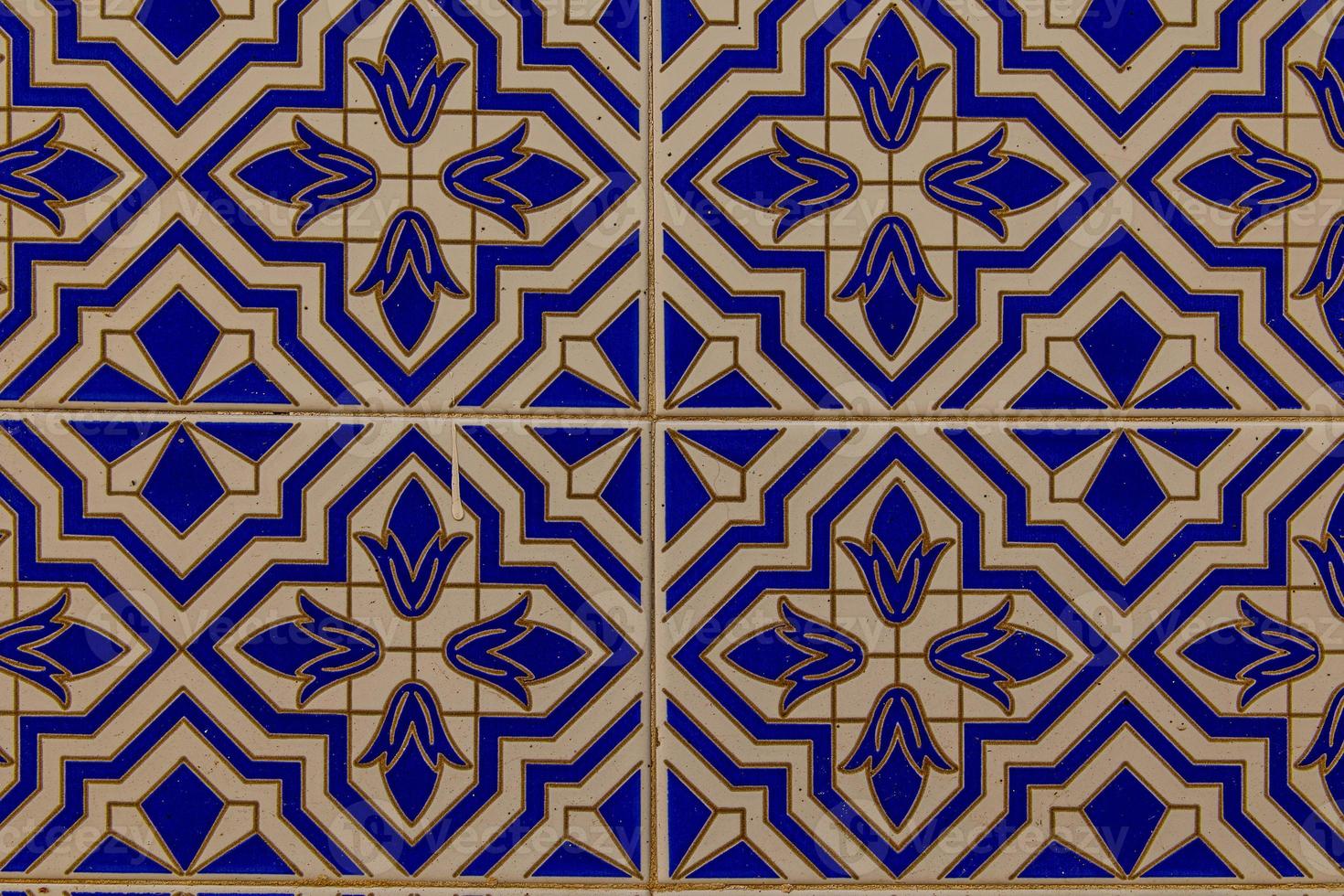 background of white-blue ceramic tiles with classic spanish patterns photo